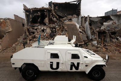 An UN peacekeeping force armoured vehicle surveys destroyed buildings in southern Lebanon. EPA
