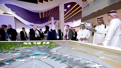 Participants of the World Route Development Forum look at a model of the Midfield Terminal which began this month. Christopher Pike / The National