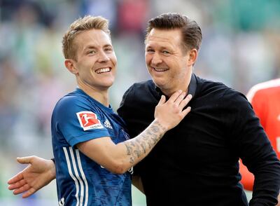 Hamburg midfielder Lewis Holtby, left, has is flourishing again since the takeover of manager Christian Titz, right. Michael Sohn / AP Photo