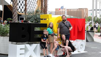 Visitors pose for photos outside the closed Belgium pavilion.