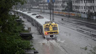 A train moves on submerged railway tracks. Reuters