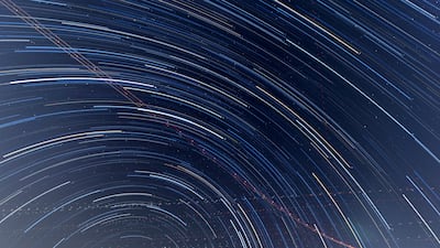 Star trails and aircraft flight paths form patterns in the night sky in this image from a Dubai Astronomy Group event in the Al Khateem Art Hub. Antonie Robertson / The National