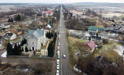 Cars stuck in traffic as families reach the Medyka-Shehyni border crossing. AFP