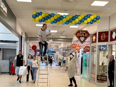 Workers hang up Eid decorations in the Rosengard Centrum shopping centre in Malmo, Sweden on May 23. Thomas Watkins / The National