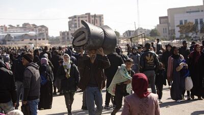 Displaced Palestinians leave Khan Younis camp in southern Gaza on Friday, after the Israeli army ordered residents to go to camps in Rafah. EPA
