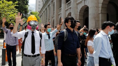 Anti-government office workers wearing masks attend a lunch time protest. Reuters