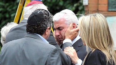 Mitch Winehouse, the father of late British singer Amy Winehouse, is consoled by friends while he attends his daughter's funeral in July 2011. Amy Winehouse was found dead at her north London home on July 23. EPA