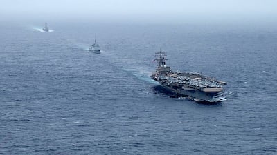 Front to back: aircraft carrier USS Ronald Reagan, French navy frigate FS Languedoc and guided-missile destroyer USS Halsey steaming in formation in the Arabian Sea on July 25. (US NAVY/AFP).