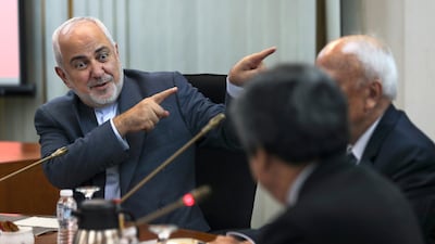 Iranian Foreign Minister Mohammad Javad Zarif, left, gestures as he speaks during a forum titled "Common Security in the Islamic World" in Kuala Lumpur, Malaysia. AP