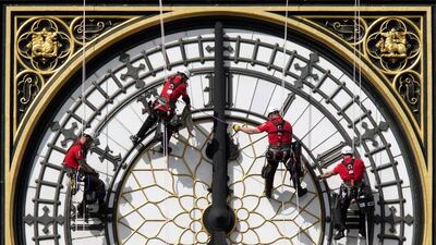Workers clean the East-facing clock face of the Elizabeth Tower of the Houses of Parliament. The bongs of the Big Ben have been running fast for two weeks. Oli Scarff / Getty Images