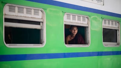 A monk looks out of the window of a train about to depart from Naypyidaw for Mandalay in Myanmar. AFP