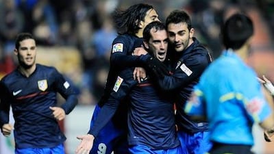 Diego Godin, centre, scored the only goal of the game between Atletico Madrid and Osasuna.