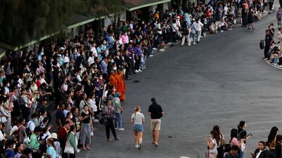 People wait in a safe area in the Thai capital. REUTERS