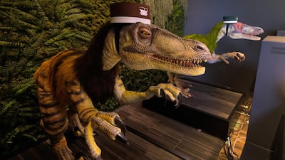 A pair of robot dinosaurs wearing bellboy hats welcome guests from the front desk at the Henn-na Hotel. AFP