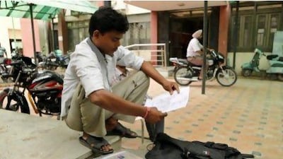 Vijay Kumar with his certificates outside an employment exchange office in New Delhi. While millions of job seekers have impressive sounding diplomas, many don’t have the skills promised from colleges and other institutes with poor standards.