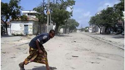 A boy runs across Howlwadag Street in Mogadishu during the third day of fighting between Somali government forces and Islamist rebels in Mogadishu.
