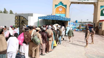 Pakistani security officials stand guard as Afghan arrive to cross the Pakistani-Afghan border in Chaman, Pakistan. EPA