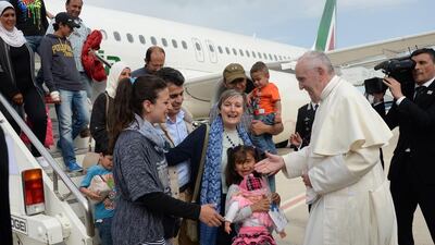 Pope Francis greets a group of Syrian refugees upon lading at Rome's Ciampino airport. (Filippo Monteforte /Pool Photo via AP)