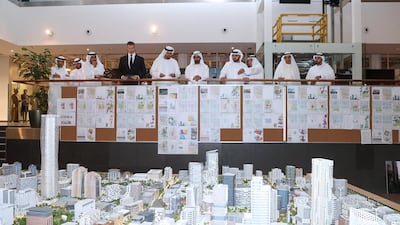 Sheikh Mohammed bin Rashid and some senior Dubai Holding officials take a bird's eye view of a scaled down Jumeirah Central project. WAM