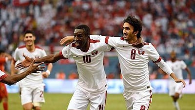 Qatar's Ali Assadalla, right, came off the bench and scored twice in the second half to lift his team past Oman in the first of two Gulf Cup of Nations semi-final matches on Sunday night in Riyadh. AFP PHOTO/ FAYEZ NURELDINE