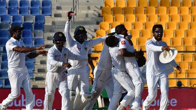 Sri Lanka's left-arm spinner Rangana Herath, centre, took the ninth 10-wicket haul of his Test career. Giuseppe Cacace / AFP