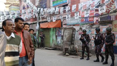 Law enforcement officials stand guard outside a voting center in Dhaka. Reuters