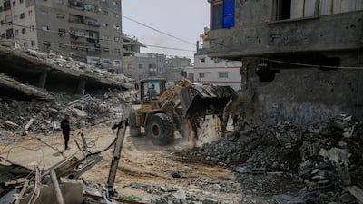 Members of the Egyptian Committee for the Reconstruction of Gaza clear a road in Gaza city. Bloomberg