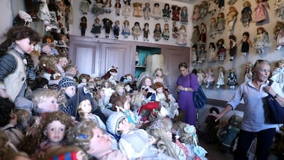 Customers look at porcelain dolls displayed in a Turkish coffee house in Ankara Castle in Ankara. AFP