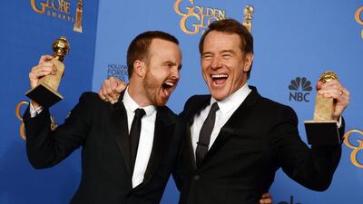 Aaron Paul, left, and Bryan Cranston pose in the press room with the award for best television series - drama for Breaking Bad. AP