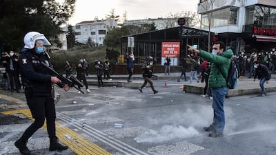 A student confronts a police officer firing rubber bullets during the clashes. AP Photo