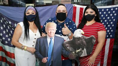 The Salazar family poses with a US President Donald Trump cutout at Trump International Golf Club, Dubai. Fans of the president were hoping for victory. All photos by Chris Whiteoak / The National