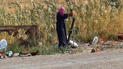 An ISIL fighter loads a mortar shell during clashes with Iraqi security forces in Ramadi, 115 kilometers west of Baghdad on November 22. AP