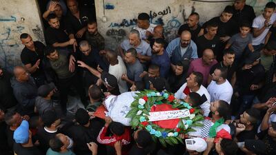 Mourners carry the body of Ramzi Zabara during his funeral at Askar refugee camp near the West Bank city of Nablus. October 28, 2022. The Palestinian Ministry of Health said Zabara, 33, and Imad Abu Rashid, 47, were shot and killed south of Nablus. EPA