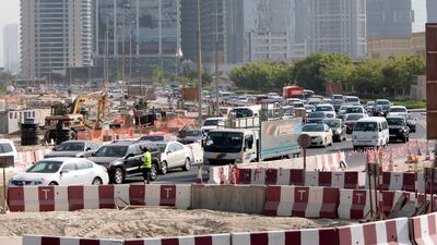 Dubai, United Arab Emirates - September 10, 2013. Traffic building up as early as 8:30 am in this small temporary roundabout at the back of the JLT towers but slowly improving due to securities or traffic enforcers around the area. ( Jeffrey E Biteng / The National ) Editor's Note; Caline M reports. *** Local Caption *** JB100913-Traffic01.jpg