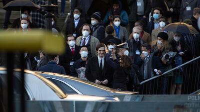 Robert Pattinson has his hair styled on set between takes. Getty Images