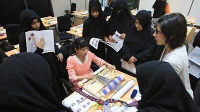 Minowa Naoko, a textile designer from Japan, teaches a new method of weaving to women at Delma Island. Ravindranath K / The National