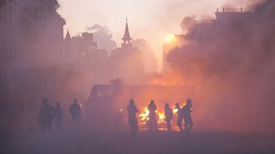 Protesters move through a cloud of tear gas during a protest at Martyrs Square. Getty Images