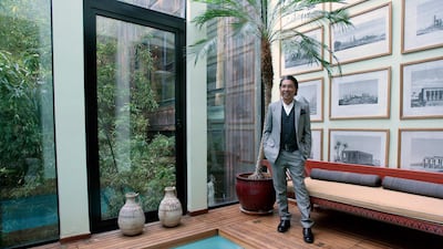 Kenzo Takada posing near the swimming pool of his loft in Paris on March 24, 2009. AFP
