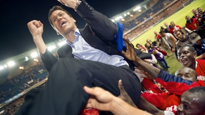 Lille coach Rudi Garcia celebrates with players at the final whistle of the French L1 football match against Paris Saint-Germain as Lille are crowned French champions. AFP