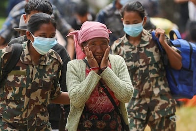 An elderly woman who survived the disaster is overcome at an army training centre in Trishuli, Nepal. Reuters