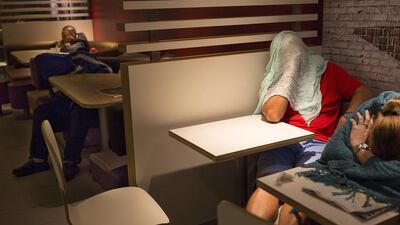 The recent death of a woman at a Hong Kong McDonald’s, where her body lay slumped at a table for hours unnoticed by other diners, has focused attention on the city’s working poor and homeless people, dubbed “McRefugees,” who spend their nights at the fast food outlet’s 24-hour branches. Vincent Yu / AP