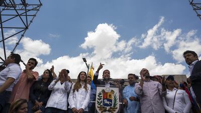Juan Guaido, centre, has defied threats of arrest as he flew into Caracas for a showdown with President Nicolas Maduro for his autocratic regime. Bloomberg