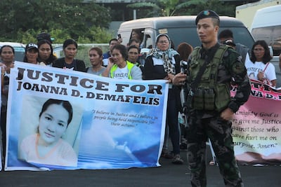 Relatives of Filipina Joanna Demafelis, who was found dead in a freezer in Kuwait, wait for the arrival of her body from Manila. AFP