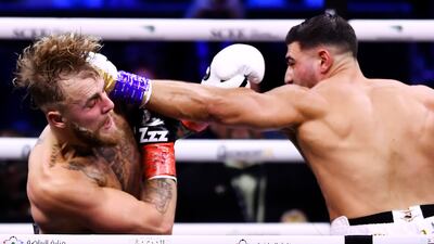 Tommy Fury, right, punches Jake Paul. EPA