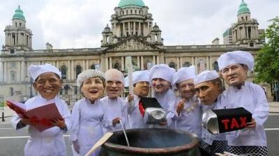 Oxfam members wear masks depicting G8 leaders outside Belfast City Hall yesterday, a day ahead of the start of the G8 summit.