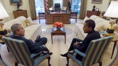 George Bush and Barack Obama meet in the Oval Office of the White House.