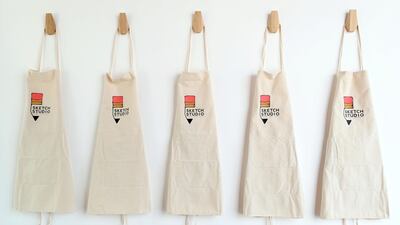 Branded aprons hang from the walls, waiting for artists to come and use them. Chris Whiteoak / The National