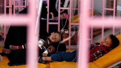 A woman sits with her sons while they are treated at a cholera treatment centre in Sanaa, Yemen. Khaled Abdullah / Reuters