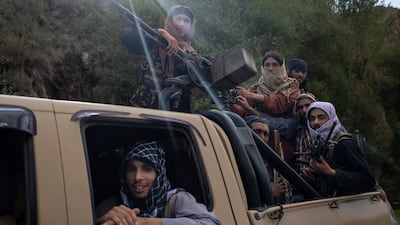Taliban fighters ride in a vehicle on a road in Wardak province, Afghanistan. AP