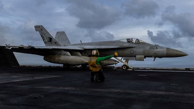 A fighter jet prepares for launch from the USS Abraham Lincoln. The aircraft carrier is part of US forces’ build-up for Operation Epic Fury in Iran. Reuters